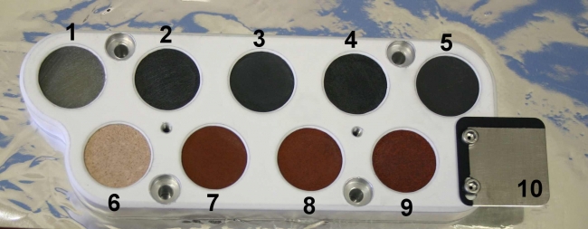 Pre-Launch Calibration Target for ChemCam, This image shows the calibration target for the Chemistry and Camera instrument on NASA's Curiosity rover before it was installed on the rover and readied fo...