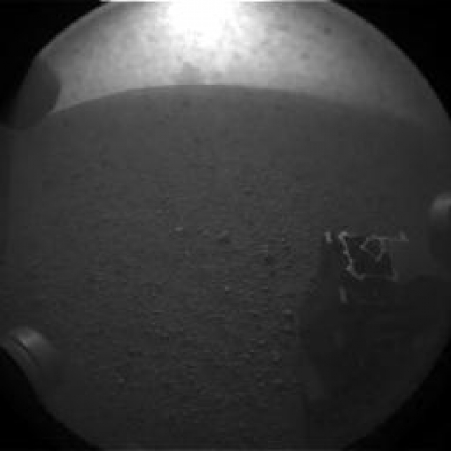 What Lies Behind Curiosity,  This is one of the first images taken by NASA's Curiosity rover, which landed on Mars the evening of Aug. 5 PDT (morning of Aug. 6 EDT). It was taken throug...