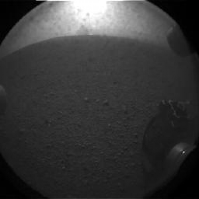 What Lies Behind Curiosity,  This is the first image taken by NASA's Curiosity rover, which landed on Mars the evening of Aug. 5 PDT (morning of Aug. 6 EDT). It was taken through a "fis...