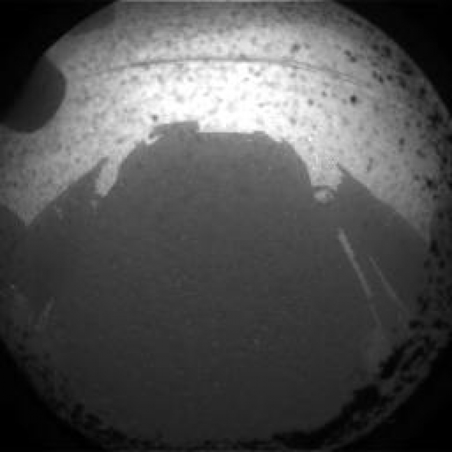 Curiosity Snaps Picture of Its Shadow,  This is one of the first images taken by NASA's Curiosity rover, which landed on Mars the evening of Aug. 5 PDT (morning of Aug. 6 EDT). It was taken throug...