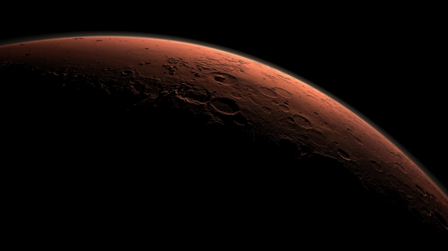 Daybreak at Gale Crater,  This computer-generated view depicts part of Mars at the boundary between darkness and daylight, with an area including Gale Crater beginning to catch morni...