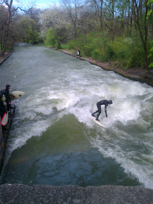 Surfer, riding the waves in the Englisher Garten