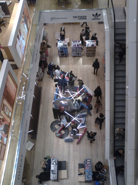 Central staircase at P & C Düsseldorf, with artsy shop interiors at basement level