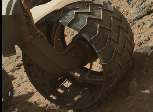 Left-Front Wheel of Curiosity Rover, Approaching Three Miles, The left-front wheel of NASA's Curiosity Mars rover shows dents and holes in this image taken during the 469th Martian day, or sol, of the rover's work on Ma...