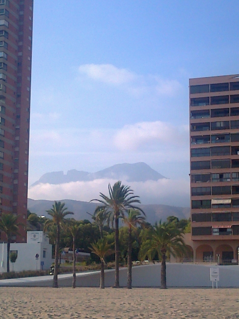 Clouds in the mountains, behind Playa de Poniente, Policia Local Playas and parts of the promenade in front